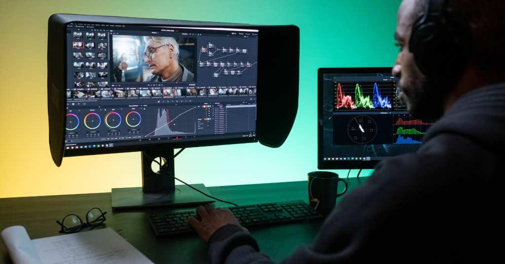 A video editor meticulously fine-tunes footage on dual monitors, showcasing live stream post-production.